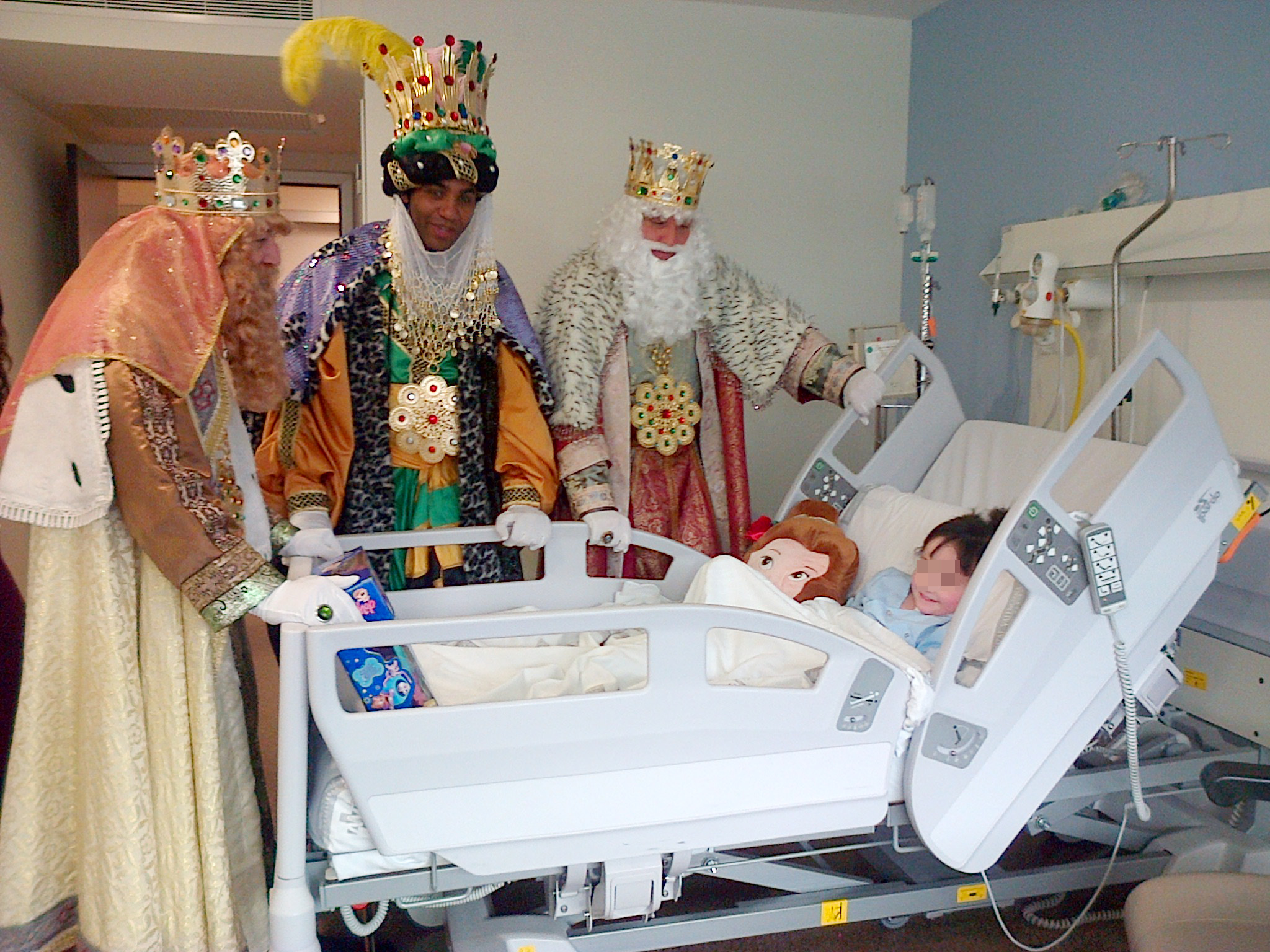 SS MM Los Reyes Magos entregan un regalo a una niña ingresada en La Fe